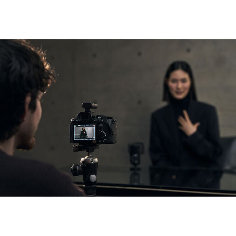 Sony A7R VI being used to film a subject, rear screen showing the video feed
